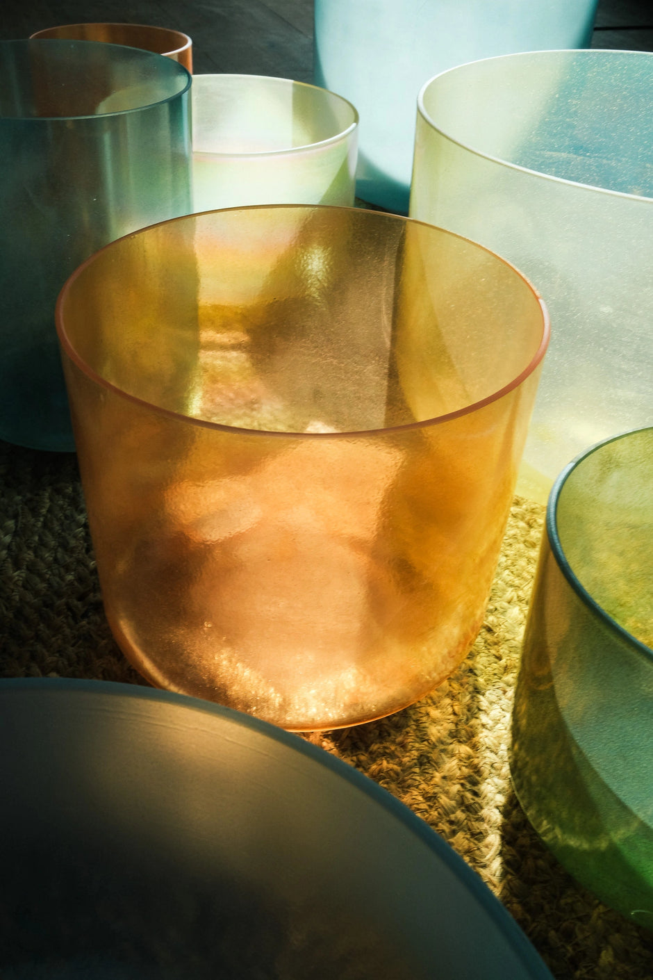 Alchemy Crystal Singing Bowls in soft green and golden tones used for sound healing and sound bath practice