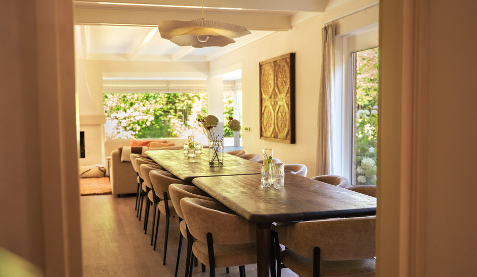 arm and cozy living and dining area with a large communal dining table