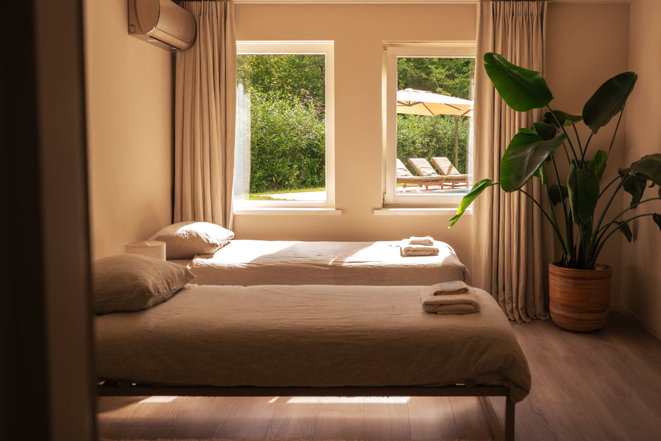 Bright and calming double bedroom with two single beds, natural light, and garden view at the retreat location